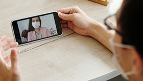 People having a video conference conversation on mobile device.